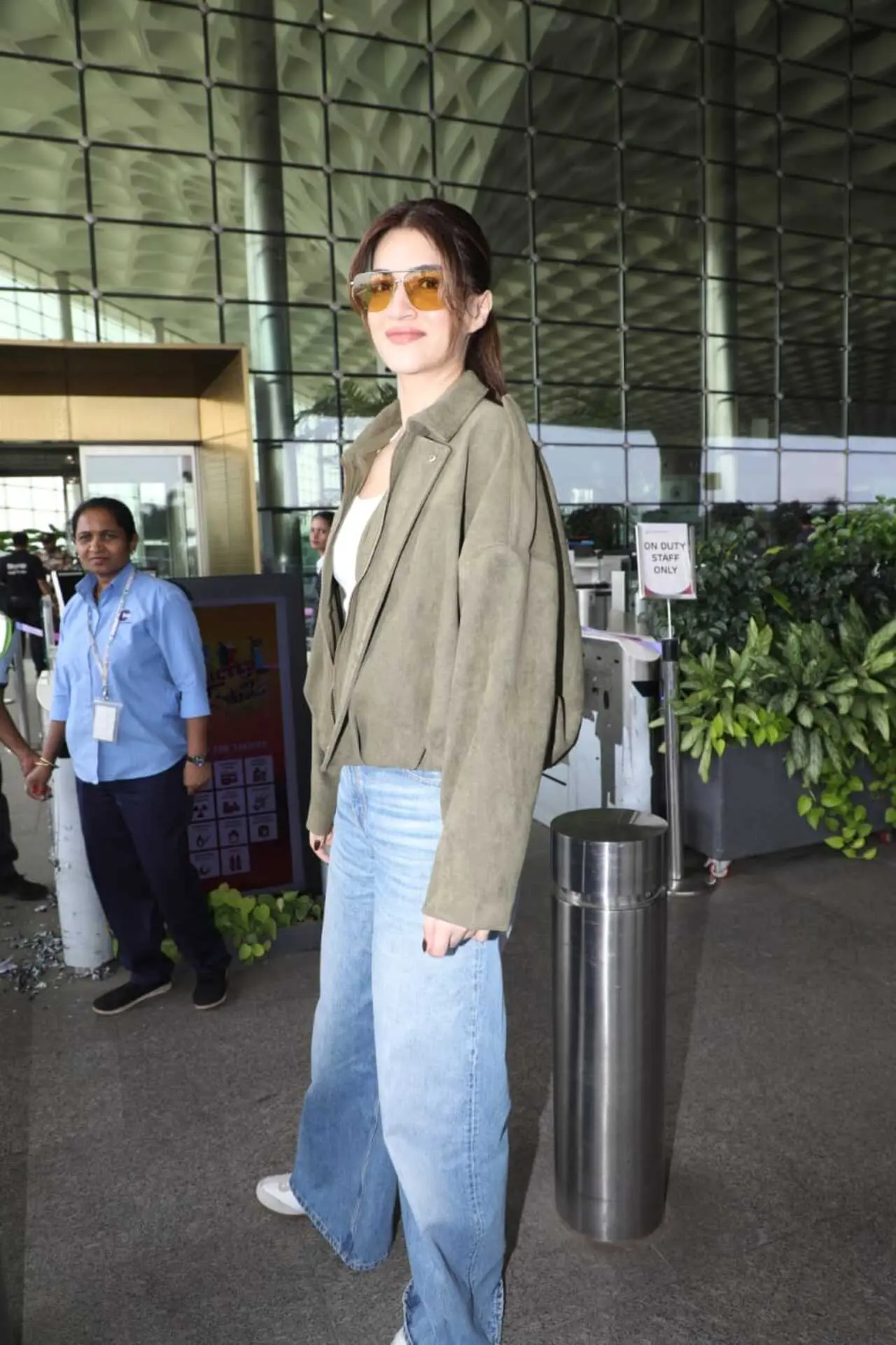 Kriti Sanon turned heads at the airport with her stylish yet effortless look. She paired a white top with classic jeans and layered it with an olive green jacket.